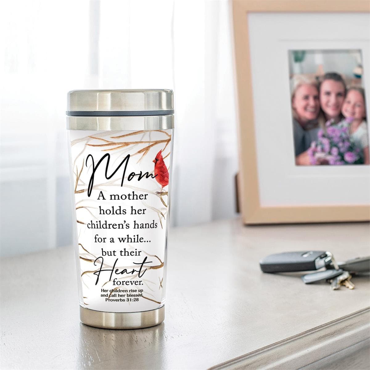 A MOTHER HOLDS HER CHILDRENS TRAVEL MUG, picture 2